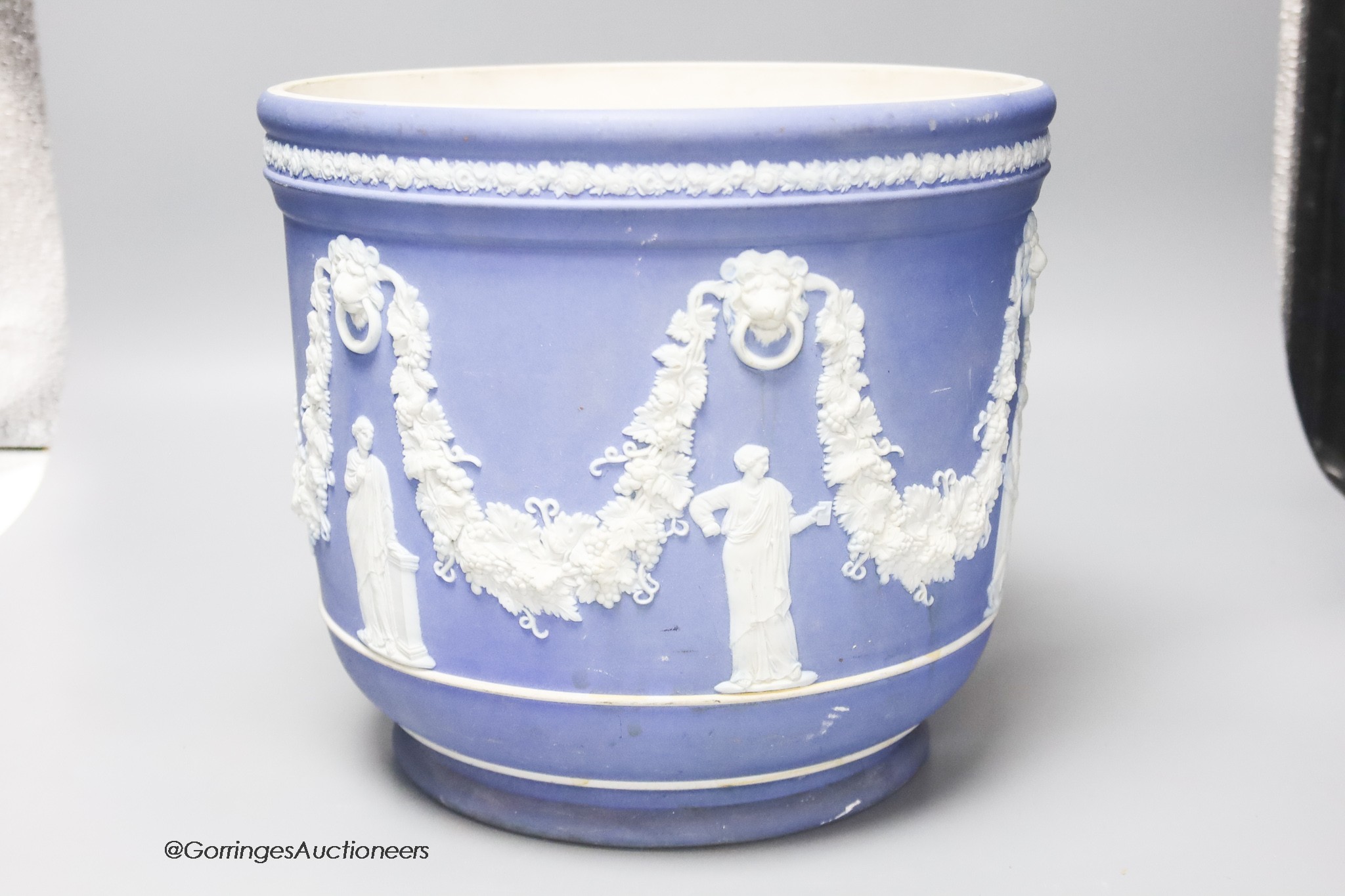 A Wedgwood blue jasper jardiniere, sprigged with muses and swags, height 23cm